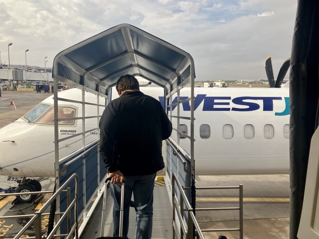 Boarding WestJet Encore's Dash 8 Q400 via Jet Bridge